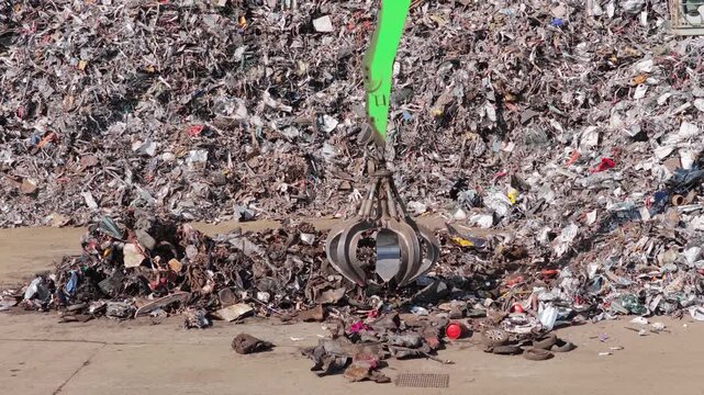 Industrial Claw Moving Scrap at Recycling Center