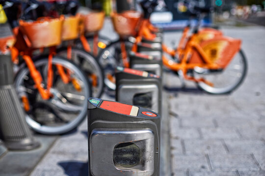 Bike sharing, bicycle rental, urban micromobility and public transport infrastructure with shared bicycles parked at a city docking station
