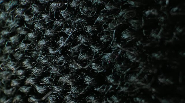 Macro close-up of dark black woven fabric texture