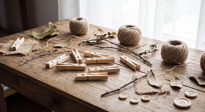 Wooden clothespins with twine and burlap on rustic table photo for craft styling
