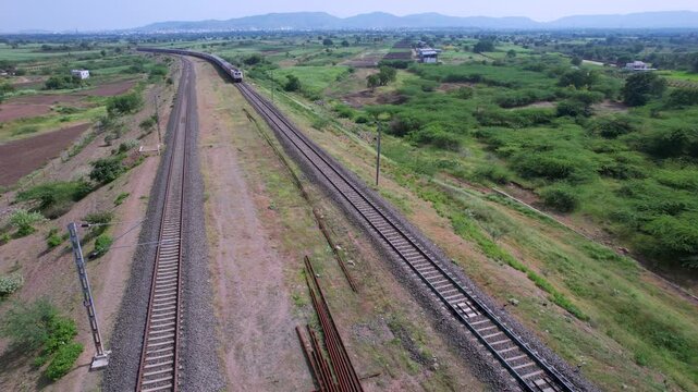 Passenger train hauled by a WAP7 electric locomotive near Pune India.