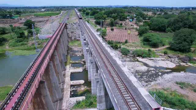 Passenger train hauled by a WAP7 electric locomotive near Pune India.