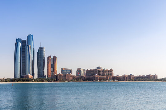 Abu Dhabi skyline with Etihad Towers skyscrapers and Emirates Palace Hotel at sea in Abu Dhabi, United Arab Emirates