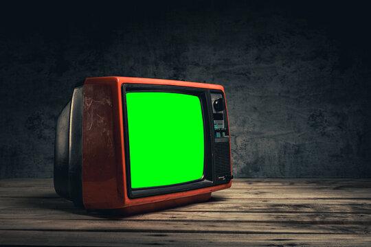Side view, vintage red old TV cut out green screen for designer on table in the black room, close-up