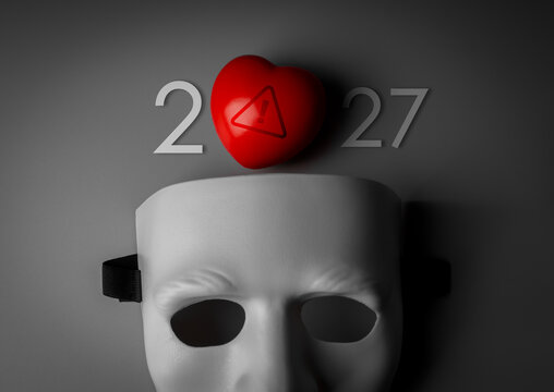 Anonymous mask beneath red warning heart and 2027 new year numbers. Romance scam awareness, catfishing, emotional deception, hidden identity and the need for safer online relationships concept.