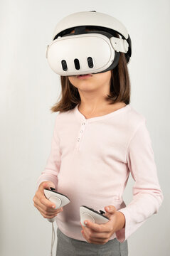 Virtual reality helmet with joysticks in girl hand