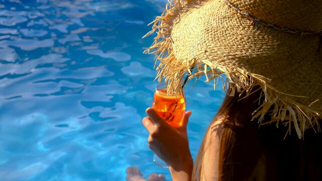 Friends drinking cocktails by the pool. Selective focus.