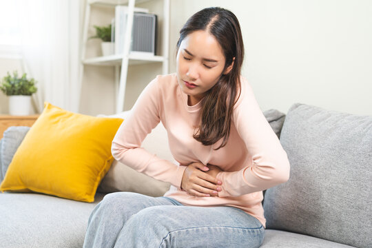 Flatulence ulcer, asian young woman, girl hands in belly, stomach pain from food poisoning, abdominal pain and digestive problem, gastritis or diarrhea. Abdomen inflammation, menstrual period people.