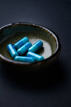 Amino acids capsules on paper background. Soft focus. Close up