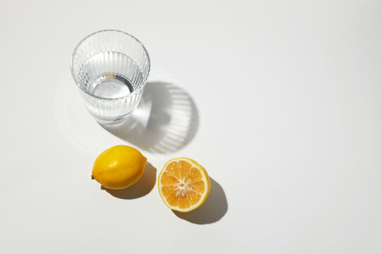 Refreshing water glass with whole and halved lemon