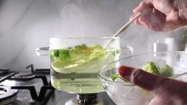 Blanching broccoli on a stovetop with glass pot, slotted spoon, and ice bath