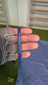 Hand holding a blue resistance band