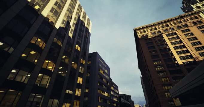 angled urban towers converging toward twilight sky, layered facades of glass and brick create dramatic perspective, moody evening light and deep urban textures.