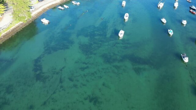 High Angle Footage of Beach and Ocean of Looe Town at River and Beach During Hot Sunny Day June 29th, 2025. Looe is a coastal town and civil parish in southeast Cornwall, England, United Kingdom.