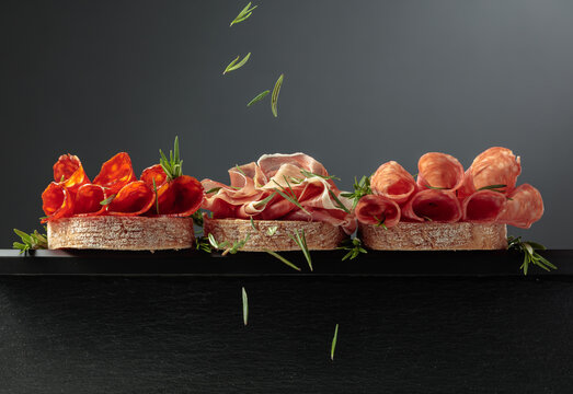 Sandwich with thin slices of Italian dry cured prosciutto, salami, and chorizo sausages.