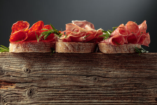 Sandwich with thin slices of Italian dry cured prosciutto, salami, and chorizo sausages.