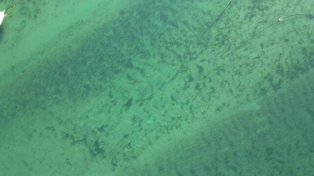 High Angle Footage of Beach and Ocean of Looe Town at River and Beach During Hot Sunny Day June 29th, 2025. Looe is a coastal town and civil parish in southeast Cornwall, England, United Kingdom.