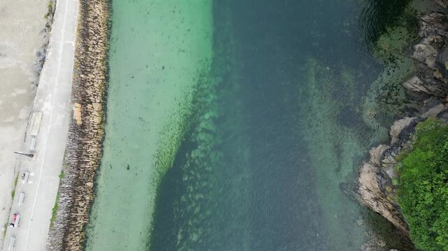 High Angle Footage of Beach and Ocean of Looe Town at River and Beach During Hot Sunny Day June 29th, 2025. Looe is a coastal town and civil parish in southeast Cornwall, England, United Kingdom.