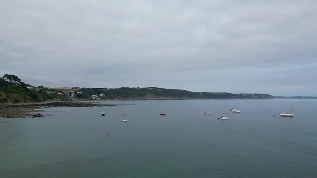 High Angle Footage of Beach and Ocean of Looe Town at River and Beach During Hot Sunny Day June 29th, 2025. Looe is a coastal town and civil parish in southeast Cornwall, England, United Kingdom.
