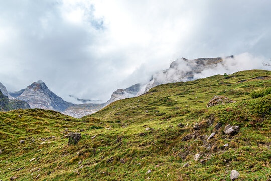 Hiking trail in Cirque de Troumouse at Heas in the Hautes-Pyrenees department in France, forming the border with Spain