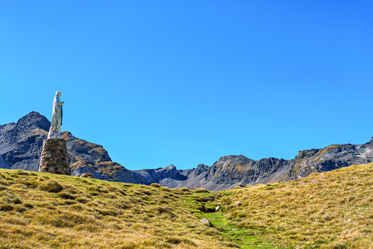 Blessed virgin Mary statue at Cirque de Troumouse, Heas in France. Meadows surrounded by dramatic mountain peaks