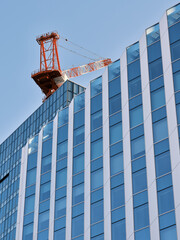Glass office building under construction with tower crane Sapporo © walk.and.look