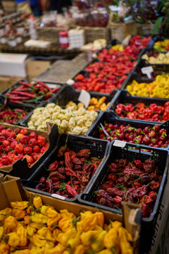 Variety of colorful hot chili peppers on market stall