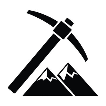 Black pickaxe on mountain peak symbolizing mining or excavation work outdoors