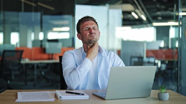 Businessman With Sore Throat Feeling Unwell At Office Desk