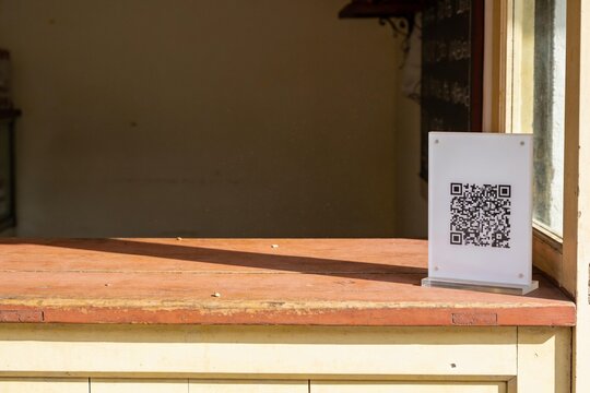 Instant payment QR code sign on a small shop counter with copy space