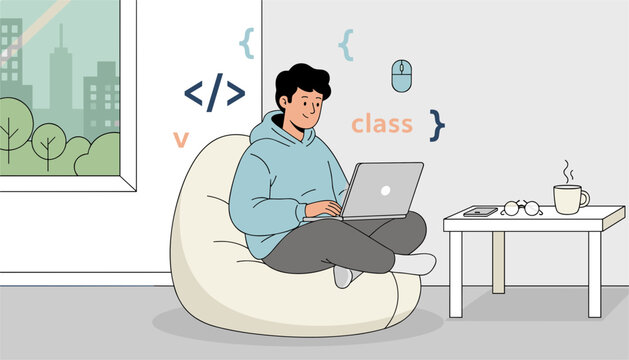 Young male programmer working comfortably on a laptop while sitting cross-legged in a bean bag chair at home.