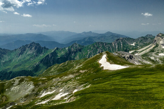 Alpine mountain panorama with green ridges, jagged peaks, valleys, and lingering snow at Mount Korab on the Albania-North Macedonia Border