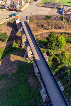 High angle view of the long drawbridge and outer grounds of Corvin Castle in Hunedoara Romania