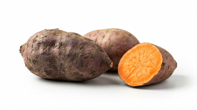Fresh whole and sliced sweet potato tubers on a kitchen table isolated on white background