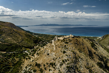 Fototapeta premium Borsh Fortress Above a Coastal Bay, Oblique Aerial View of Historic Stone Walls and Distant Mountains