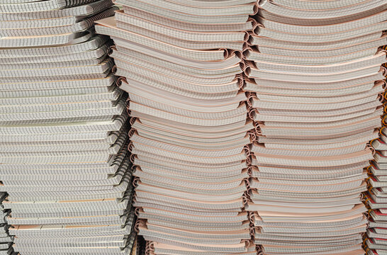 Pile of school notebooks on shelf