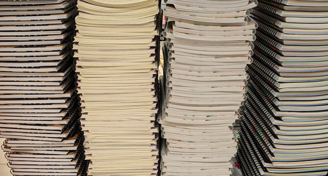 Pile of school notebooks on shelf