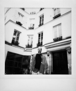 Man standing in Parisian courtyard