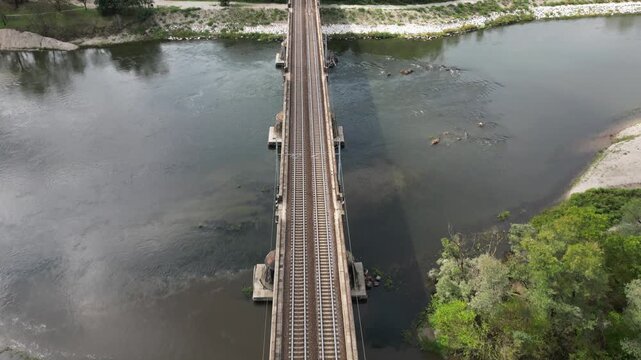 Milan &ndash; Pavia &ndash; Genoa railway line: drone view of a regional train and an Intercity train crossing the bridge over the Ticino River in Pavia, Italian Railways and the modernization of the rail network