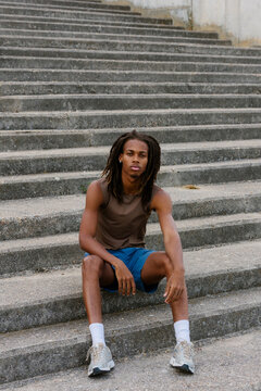 Black professional runner posing with confidence on a sunny morning