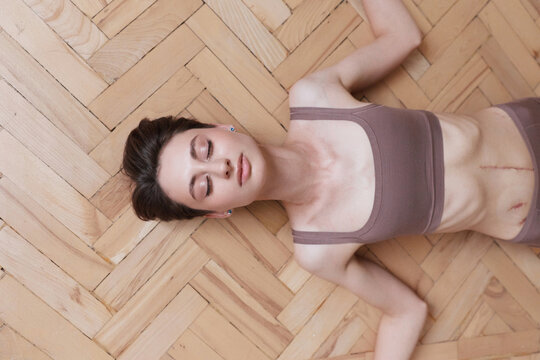 Woman with Abdominal Scar Relax On Floor