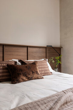 Textured brown pillows on white bedding