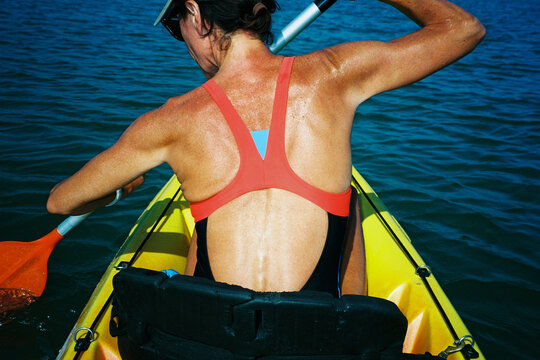 Woman Paddling Yellow Kayak