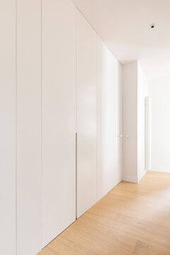 Minimalist hallway with white wardrobes