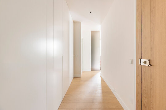 Minimalist hallway leading to frosted door