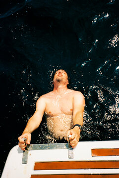 Man Climbing Boat Ladder