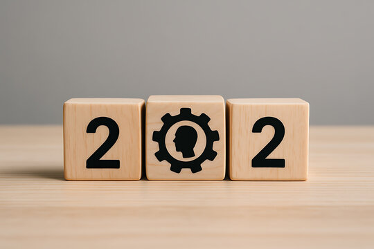 Wooden blocks displaying the numbers 2022 and a gear with a head silhouette