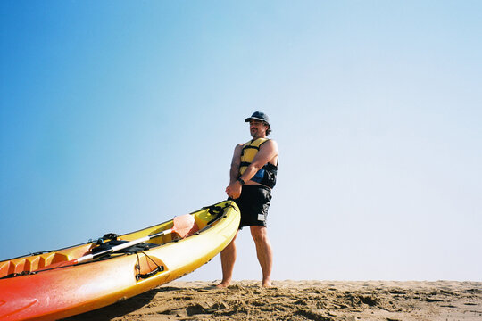 Man Pulling Beach Kayak