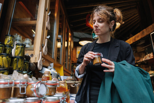 Woman shopping for local preserves at market