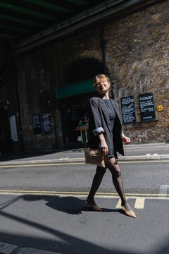 Woman smiling walking city street urban fashion